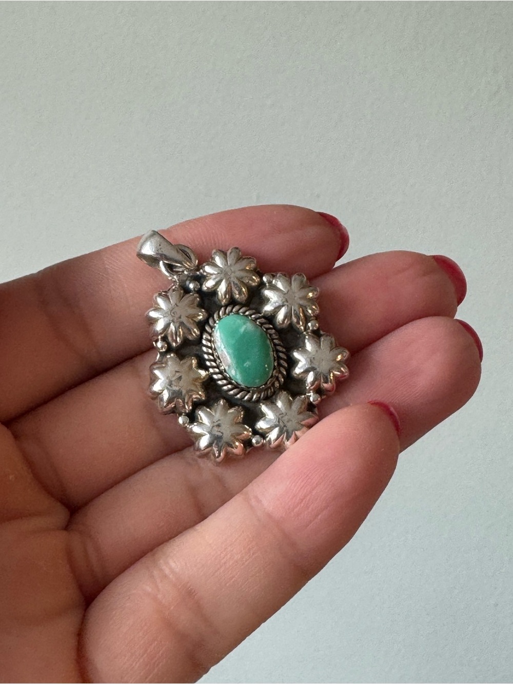 925 silver pendant features a central oval-shaped stone turquoise